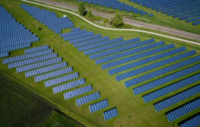 Rows of solar panels in a field.