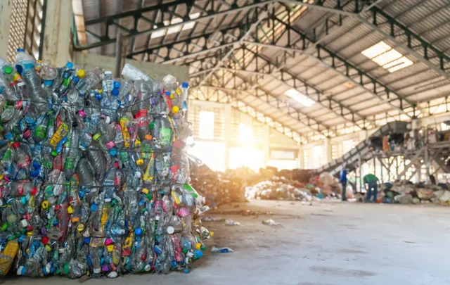 A stack of plastic bottles in a recycling plant.